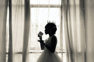 Woman in White Wedding Gown Holding Cup